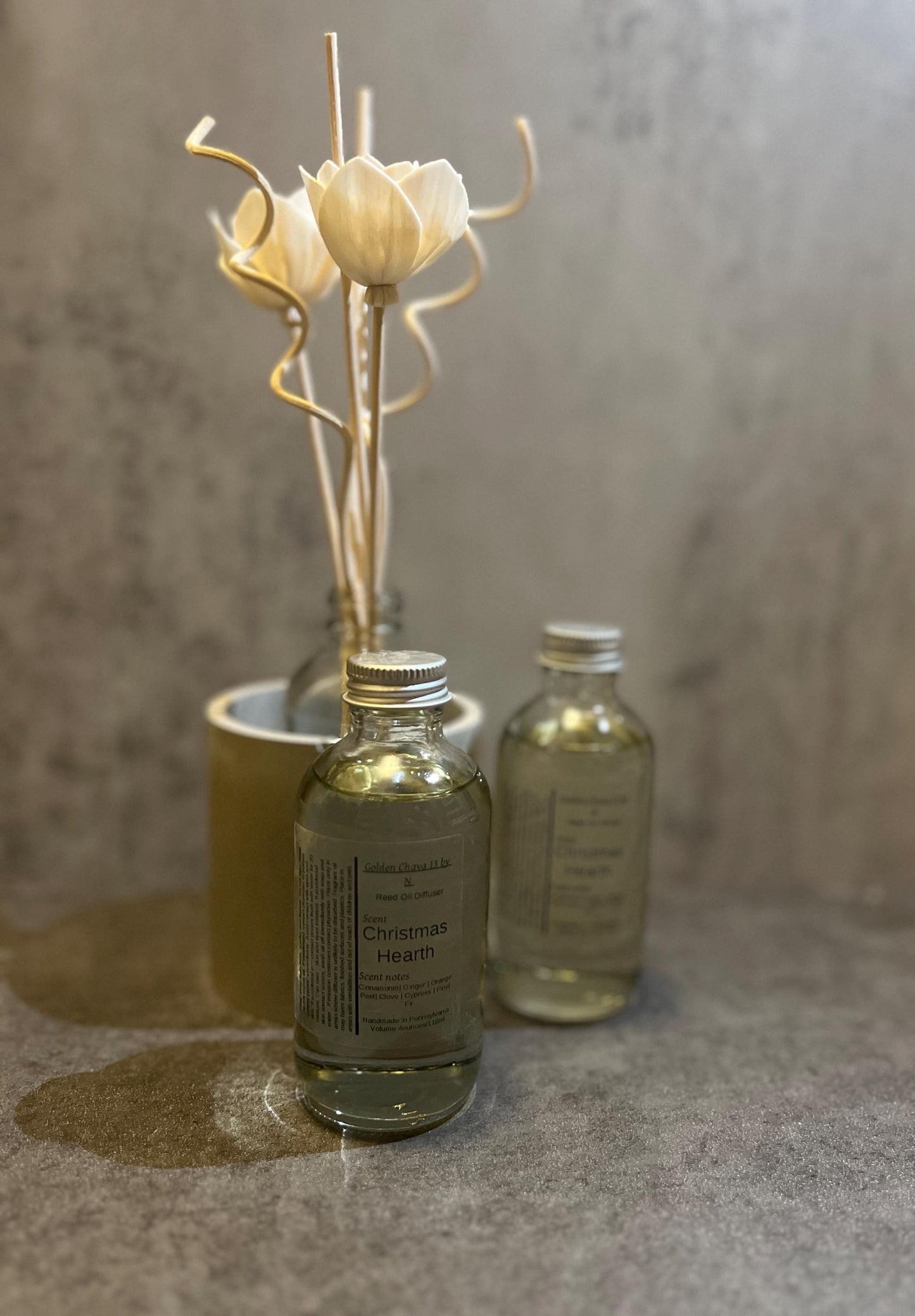4 oz Reed Diffuser oil in glass bottle with flower and spiral reed plus straight wooden reed sticks.