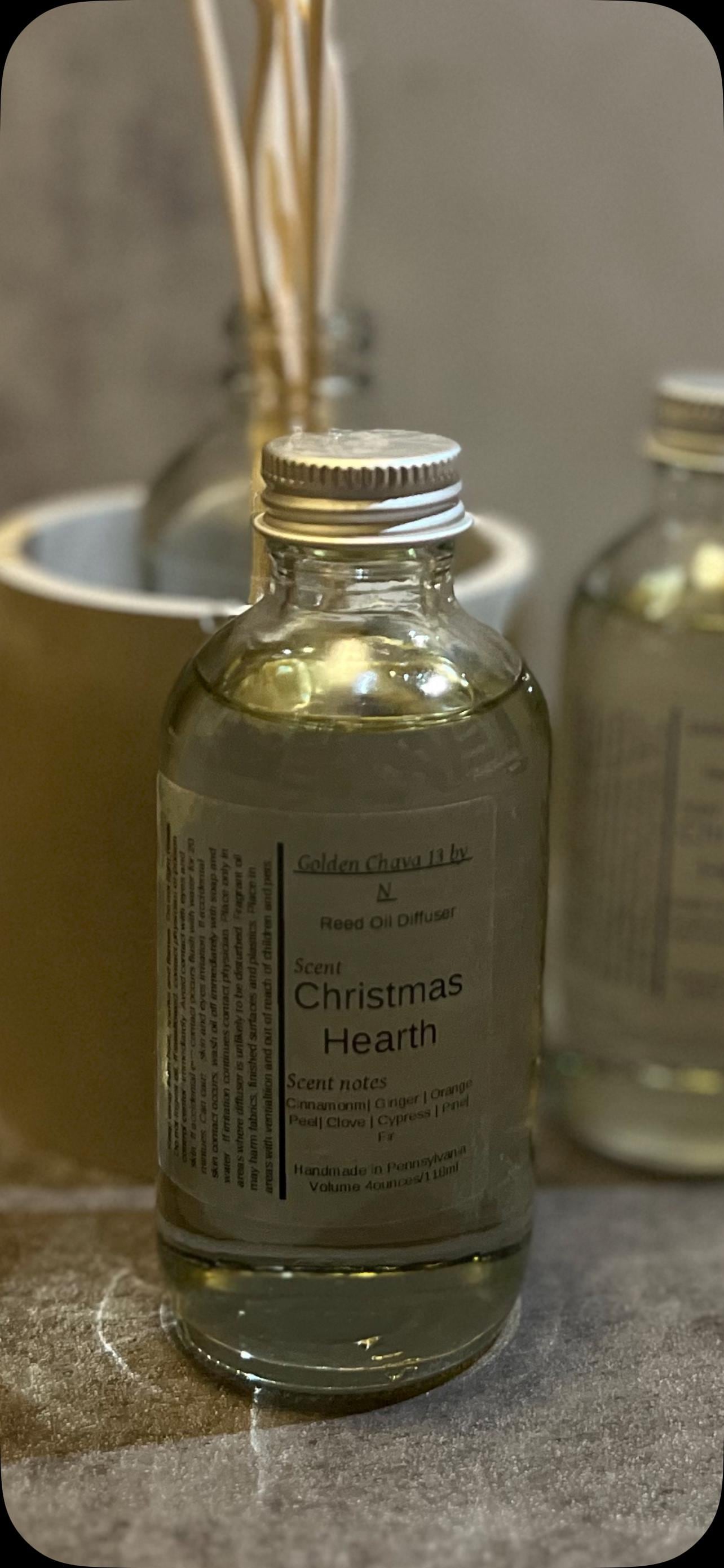 4 oz Reed Diffuser Christmas Hearth scent in a glass bottle, metal-cap, mixed reeds: flower, spiral, straight sticks.