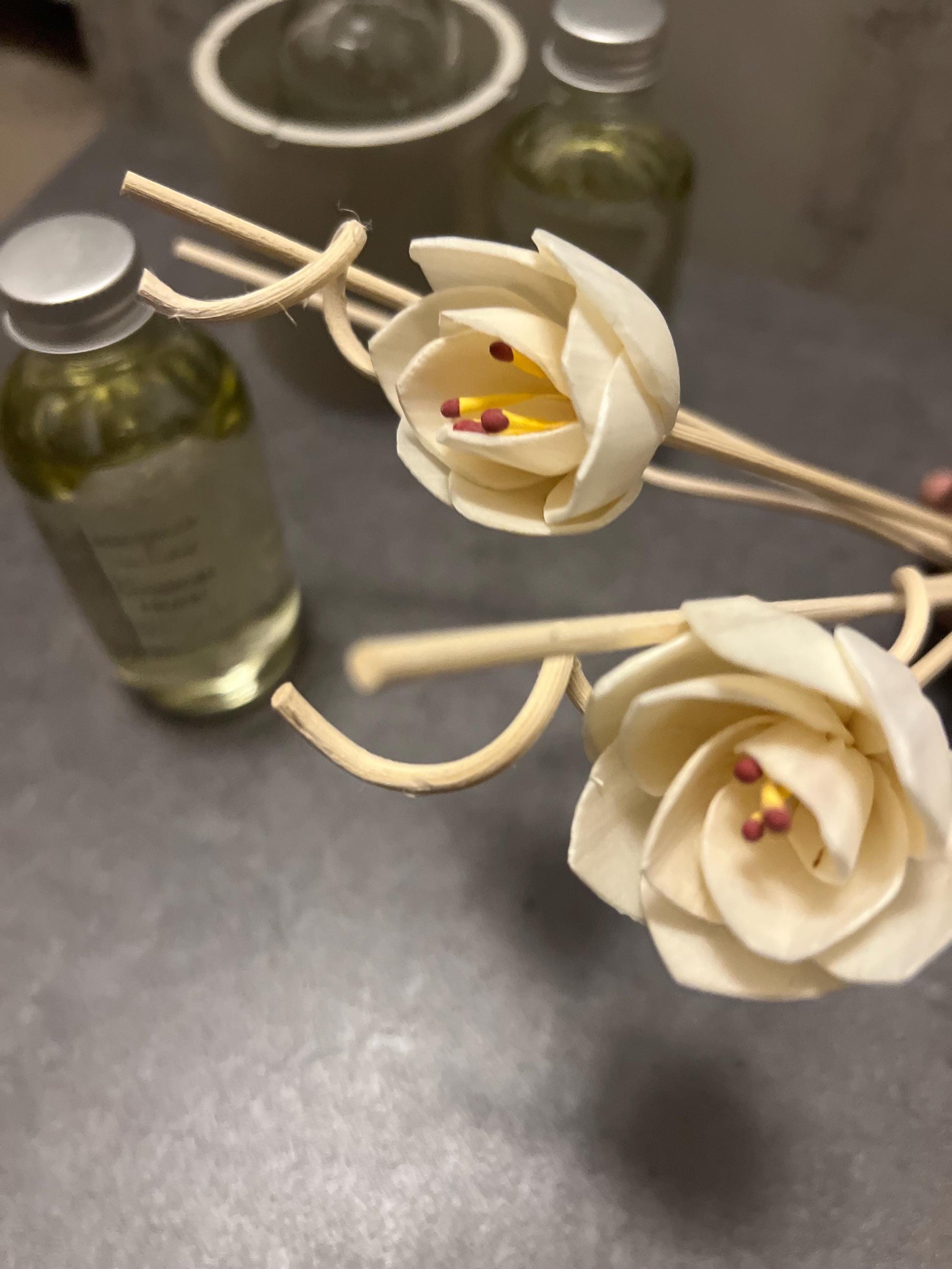 4 oz Reed Diffuser set with glass bottle, flower and spiral reed toppers, and three straight wooden sticks.